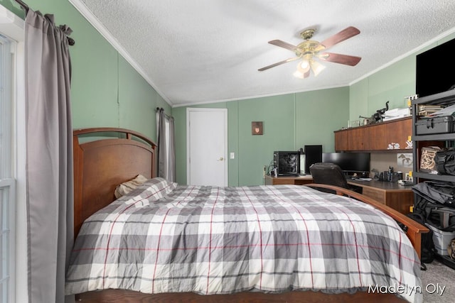 bedroom with a textured ceiling, crown molding, vaulted ceiling, a decorative wall, and a ceiling fan