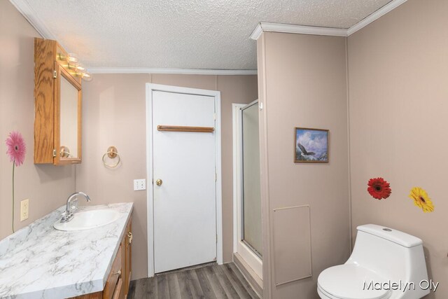 full bath with a textured ceiling, wood finished floors, and a stall shower