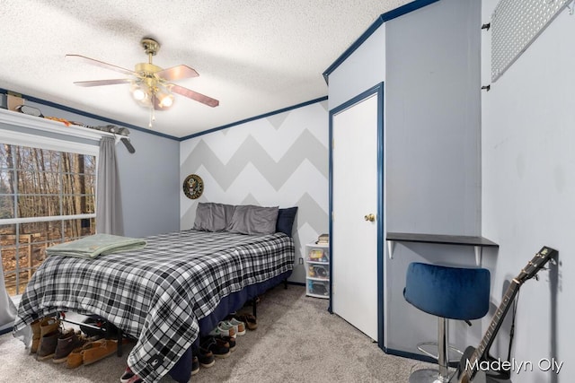 bedroom featuring a ceiling fan, carpet floors, and a textured ceiling