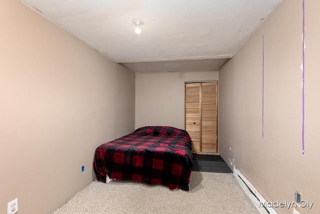 carpeted bedroom with a baseboard radiator