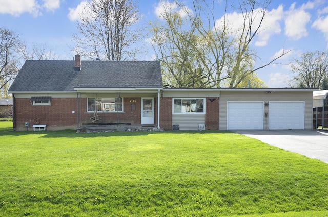 view of front facade featuring driveway, a front lawn, brick siding, and an attached garage