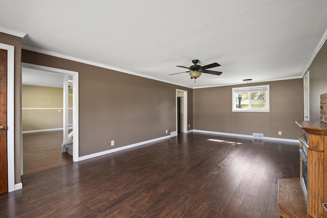 unfurnished living room with crown molding, ceiling fan, baseboards, a fireplace, and wood finished floors