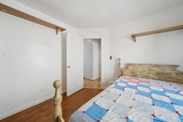 bedroom featuring baseboards and wood finished floors