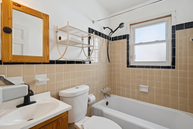 bathroom with tile walls, shower / bathing tub combination, vanity, and toilet