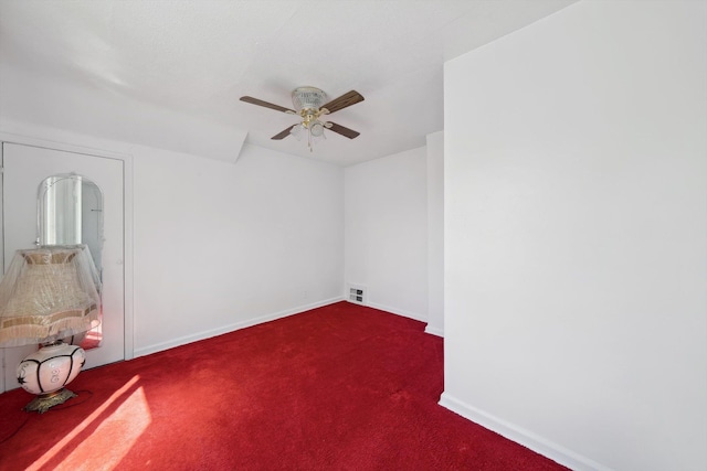 unfurnished room featuring baseboards, a ceiling fan, carpet flooring, and visible vents