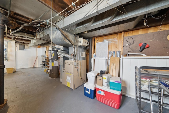 unfinished below grade area featuring heating unit, gas water heater, and electric panel