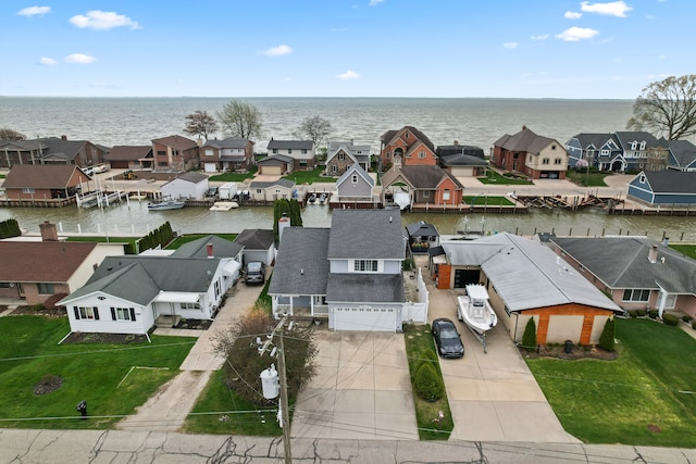 bird's eye view featuring a water view and a residential view