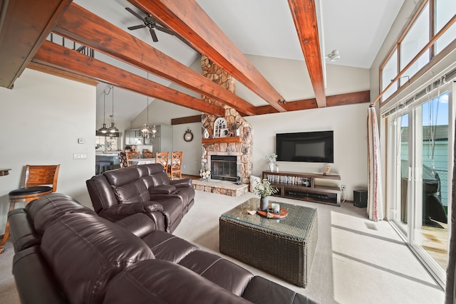 living area with carpet floors, high vaulted ceiling, a stone fireplace, ceiling fan with notable chandelier, and beamed ceiling