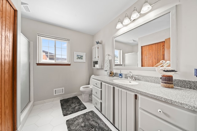 bathroom with visible vents, an enclosed shower, tile patterned floors, and vanity