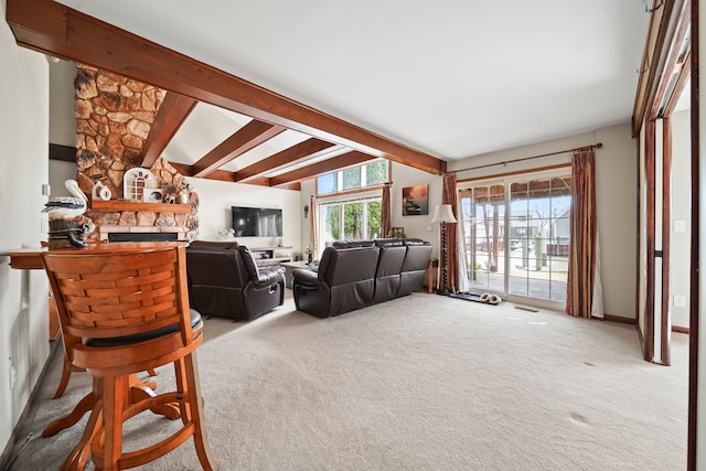 carpeted living room with vaulted ceiling with beams, a fireplace, and visible vents