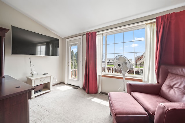 sitting room featuring carpet flooring, baseboards, and lofted ceiling