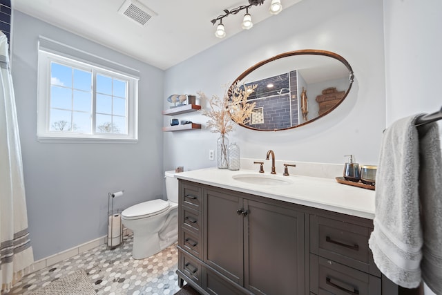 bathroom featuring visible vents, vanity, curtained shower, toilet, and baseboards