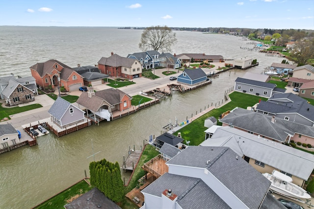 birds eye view of property featuring a water view and a residential view