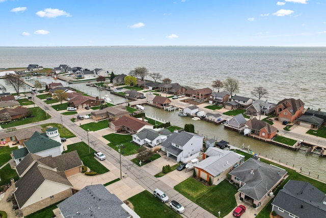 bird's eye view featuring a water view and a residential view