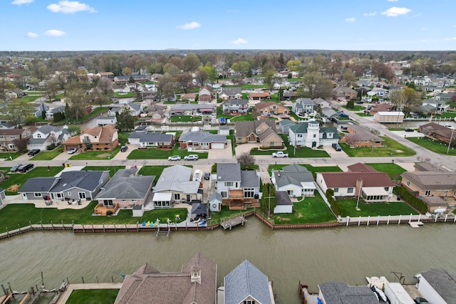 drone / aerial view with a water view and a residential view