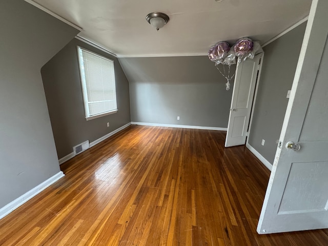 bonus room featuring visible vents, baseboards, vaulted ceiling, and wood-type flooring