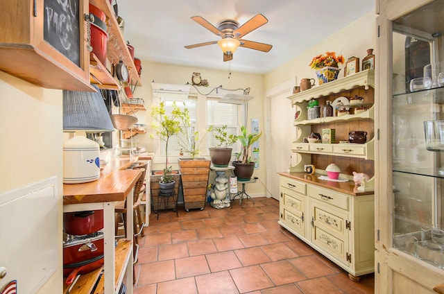 home office featuring ceiling fan and tile patterned flooring