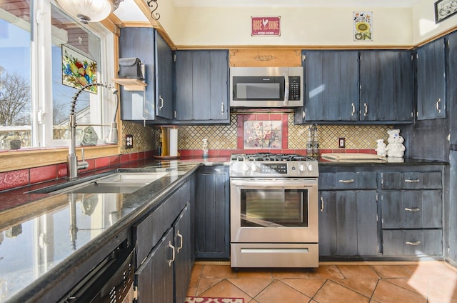 kitchen with a sink, light tile patterned floors, tasteful backsplash, and stainless steel appliances