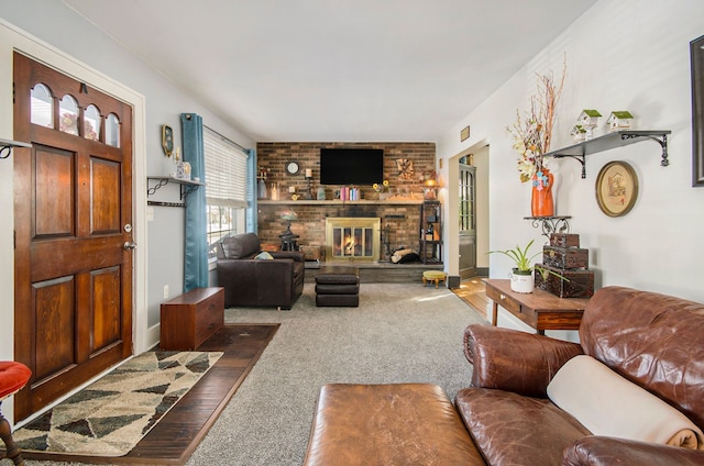 carpeted living area with a brick fireplace