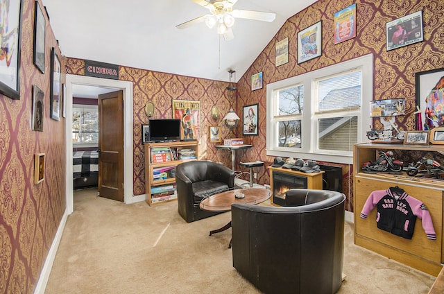 sitting room featuring carpet flooring, a ceiling fan, lofted ceiling, and wallpapered walls