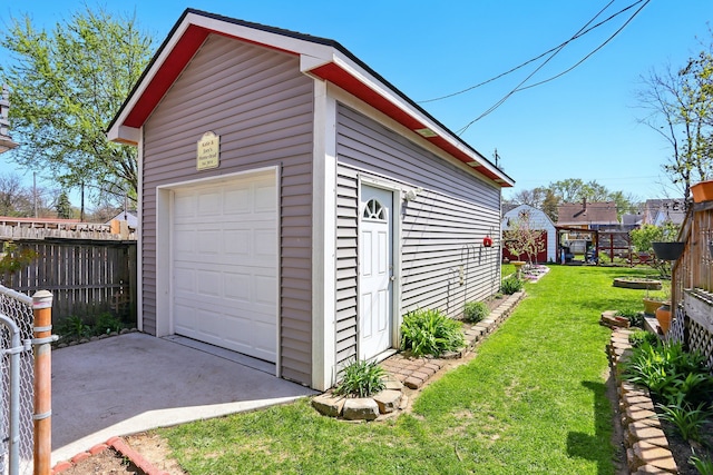 detached garage featuring fence