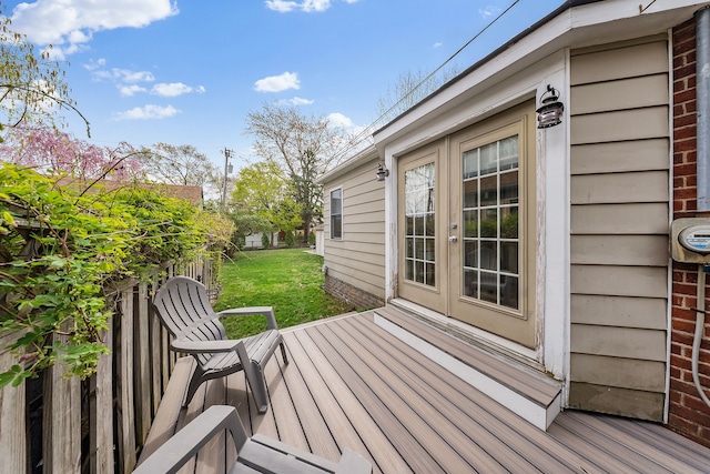 wooden terrace featuring a yard and french doors