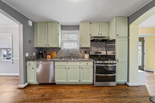 kitchen featuring a sink, green cabinets, stainless steel appliances, and under cabinet range hood