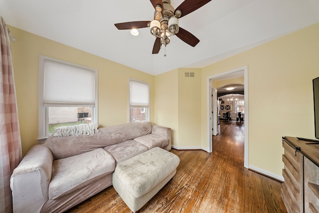 living room with wood finished floors, visible vents, ceiling fan, and plenty of natural light