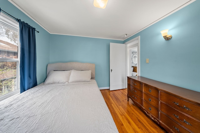 bedroom with baseboards, wood finished floors, and crown molding