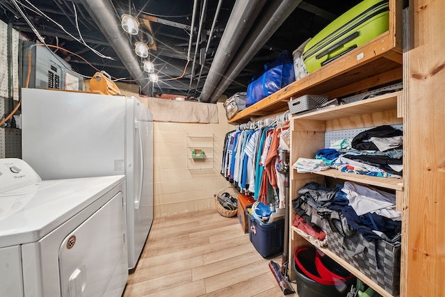 washroom featuring washer and dryer, light wood-style flooring, and laundry area