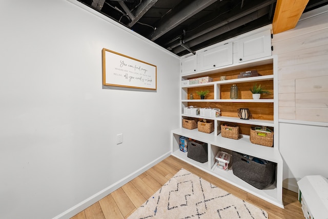 mudroom featuring baseboards and light wood finished floors