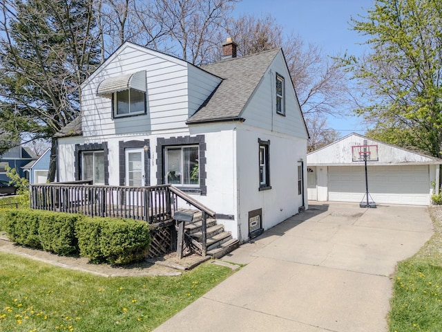 13705 Julius Ave, Warren, MI 48089 - view of front facade with roof with shingles, an outbuilding, a detached garage, and a chimney