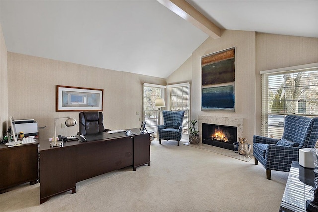 home office featuring a healthy amount of sunlight, a high end fireplace, beamed ceiling, and light colored carpet