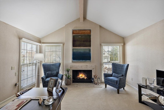 carpeted office featuring baseboards, lofted ceiling with beams, and a lit fireplace