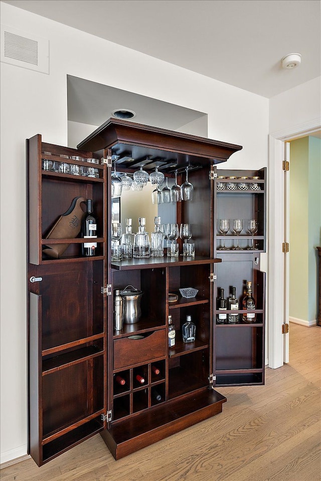 bar featuring wood finished floors and visible vents