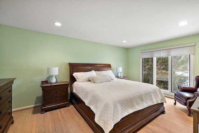 bedroom featuring baseboards, recessed lighting, and light wood finished floors