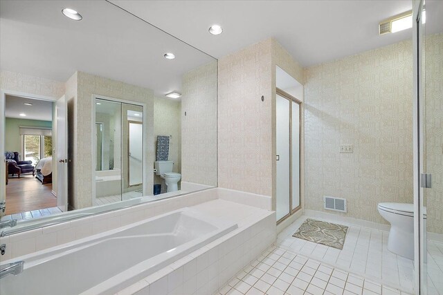 full bathroom featuring connected bathroom, toilet, a shower stall, visible vents, and a bath