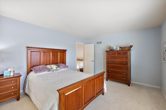 bedroom with baseboards, visible vents, and light carpet