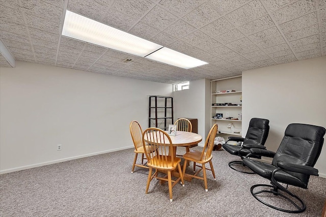 carpeted dining area with baseboards