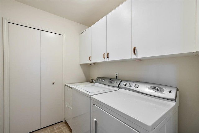 laundry room featuring cabinet space and separate washer and dryer