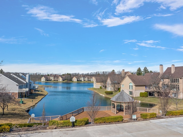 water view with a gazebo, fence, and a residential view