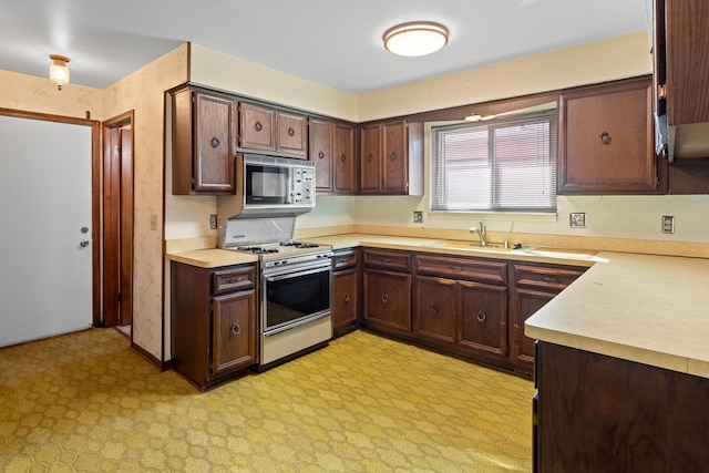 15895 Bexley St, Clinton Township, MI 48038 - kitchen featuring built in microwave, a sink, white gas range, light countertops, and light floors