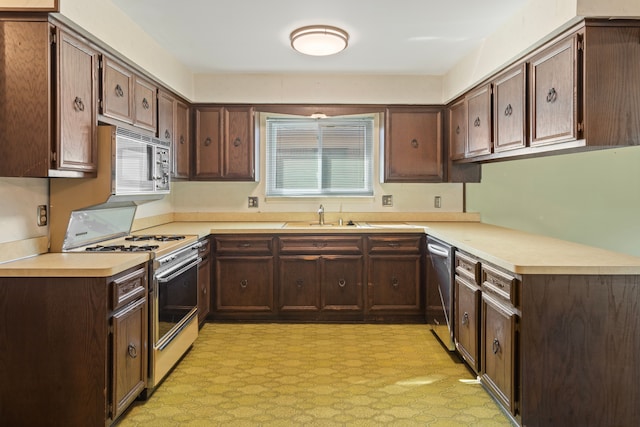 15895 Bexley St, Clinton Township, MI 48038 - kitchen featuring dark brown cabinetry, stainless steel appliances, light countertops, and a sink