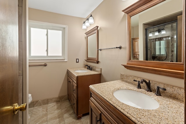 15895 Bexley St, Clinton Township, MI 48038 - bathroom featuring two vanities, baseboards, a stall shower, and a sink