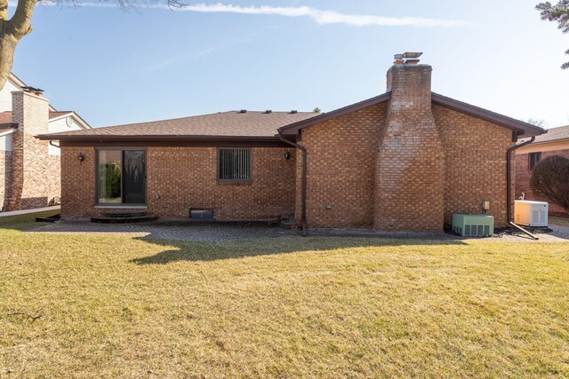 15895 Bexley St, Clinton Township, MI 48038 - back of house with a chimney, brick siding, a yard, and roof with shingles