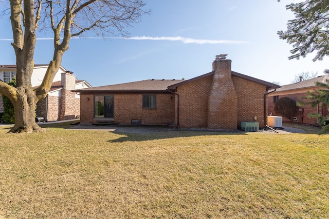 15895 Bexley St, Clinton Township, MI 48038 - rear view of property featuring a chimney, brick siding, central AC unit, and a yard