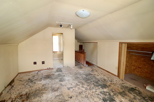 bonus room featuring baseboards and vaulted ceiling