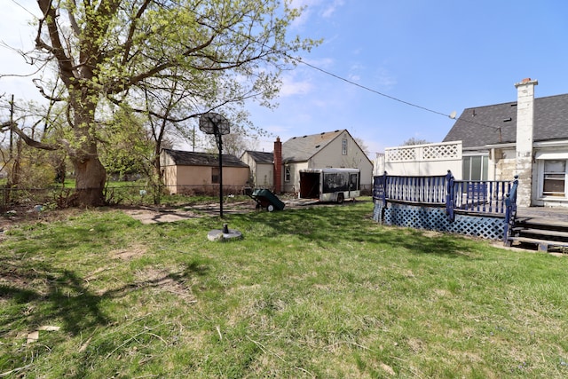view of yard with a deck and fence
