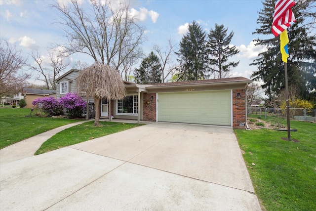 view of front of property with fence, a front lawn, brick siding, a garage, and driveway