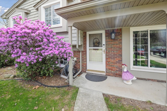 property entrance with brick siding